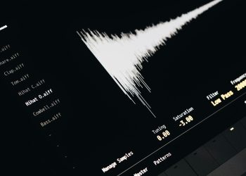 Close-up of a digital audio editing interface displaying sound waves and file names.