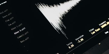 Close-up of a digital audio editing interface displaying sound waves and file names.