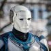 Close-up of a futuristic humanoid robot with metallic armor and blue LED eyes.