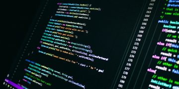 Close-up of colorful programming code on a computer screen, showcasing digital technology.