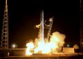 Modern shuttle spaceship launching from station against dark night sky and beginning mission