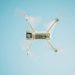 A sleek white drone flying under a clear blue sky, capturing aerial views.