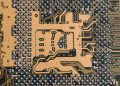 Detailed view of a circuit board showcasing intricate patterns and metallic connections.