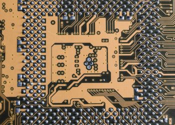 Detailed view of a circuit board showcasing intricate patterns and metallic connections.