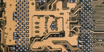 Detailed view of a circuit board showcasing intricate patterns and metallic connections.