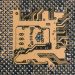 Detailed view of a circuit board showcasing intricate patterns and metallic connections.
