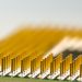 Detailed macro shot of a CPU microchip with focus on golden pins, highlighting technology details.