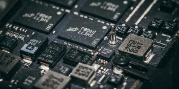 Detailed close-up of electronic microchips on a circuit board, showcasing technology and engineering intricacies.