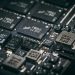 Detailed close-up of electronic microchips on a circuit board, showcasing technology and engineering intricacies.