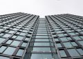 Low angle view of a modern office building with glass facade in Warsaw, Poland.