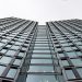 Low angle view of a modern office building with glass facade in Warsaw, Poland.