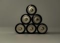 Metallic AA batteries stacked in a pyramid shape, symbolizing power and energy storage.
