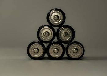 Metallic AA batteries stacked in a pyramid shape, symbolizing power and energy storage.