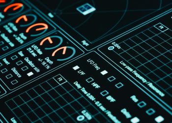 Close-up of a digital interface showcasing futuristic graphs and data analytics in low light.