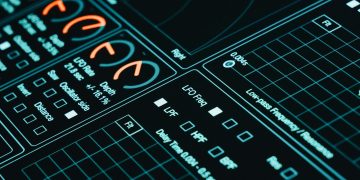 Close-up of a digital interface showcasing futuristic graphs and data analytics in low light.