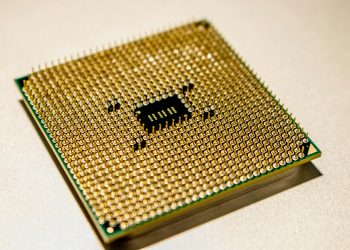 Detailed close-up of a golden microprocessor chip, ideal for technology concepts.