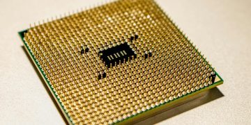 Detailed close-up of a golden microprocessor chip, ideal for technology concepts.
