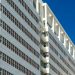 A striking white architectural structure in The Hague, Netherlands against a clear blue sky.