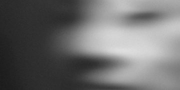 Blurred grayscale abstract portrait creating a mysterious effect.