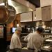 Two chefs working in a professional kitchen, highlighting culinary expertise and teamwork.