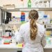 A female scientist conducting research in a well-equipped laboratory, focusing on chemical analysis.