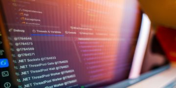 Focused view of a computer screen displaying code and debug information.