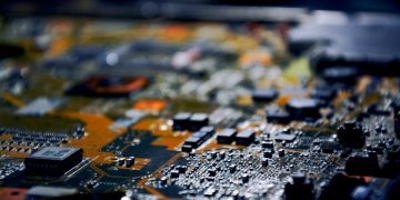 Detailed close-up view of electronic circuit board, showcasing modern technology.