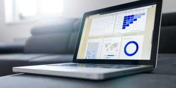 Sleek laptop showcasing data analytics and graphs on the screen in a bright room