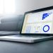 Sleek laptop showcasing data analytics and graphs on the screen in a bright room