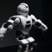 Close-up of a futuristic humanoid robot under dramatic lighting in dark ambiance.