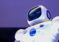 A modern humanoid robot with digital face and luminescent screen, symbolizing innovation in technology.