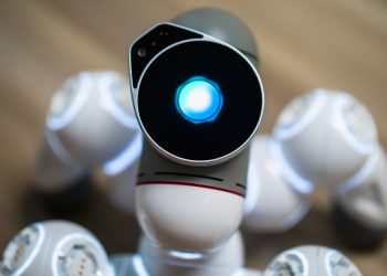 Detailed close-up shot of a futuristic toy robot with a glowing head, focused on innovation.