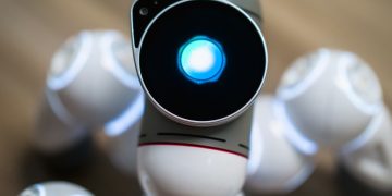 Detailed close-up shot of a futuristic toy robot with a glowing head, focused on innovation.