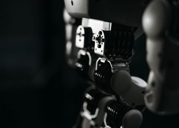 Detailed close-up of a robot's mechanical components, emphasized by moody studio lighting.