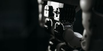 Detailed close-up of a robot's mechanical components, emphasized by moody studio lighting.