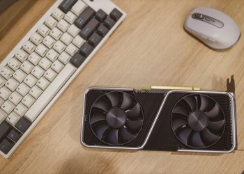 Top view of a desktop with a keyboard, mouse, and graphics card.