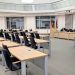 Spacious and modern meeting room in Niedersachsen, Germany, with desks and flags.