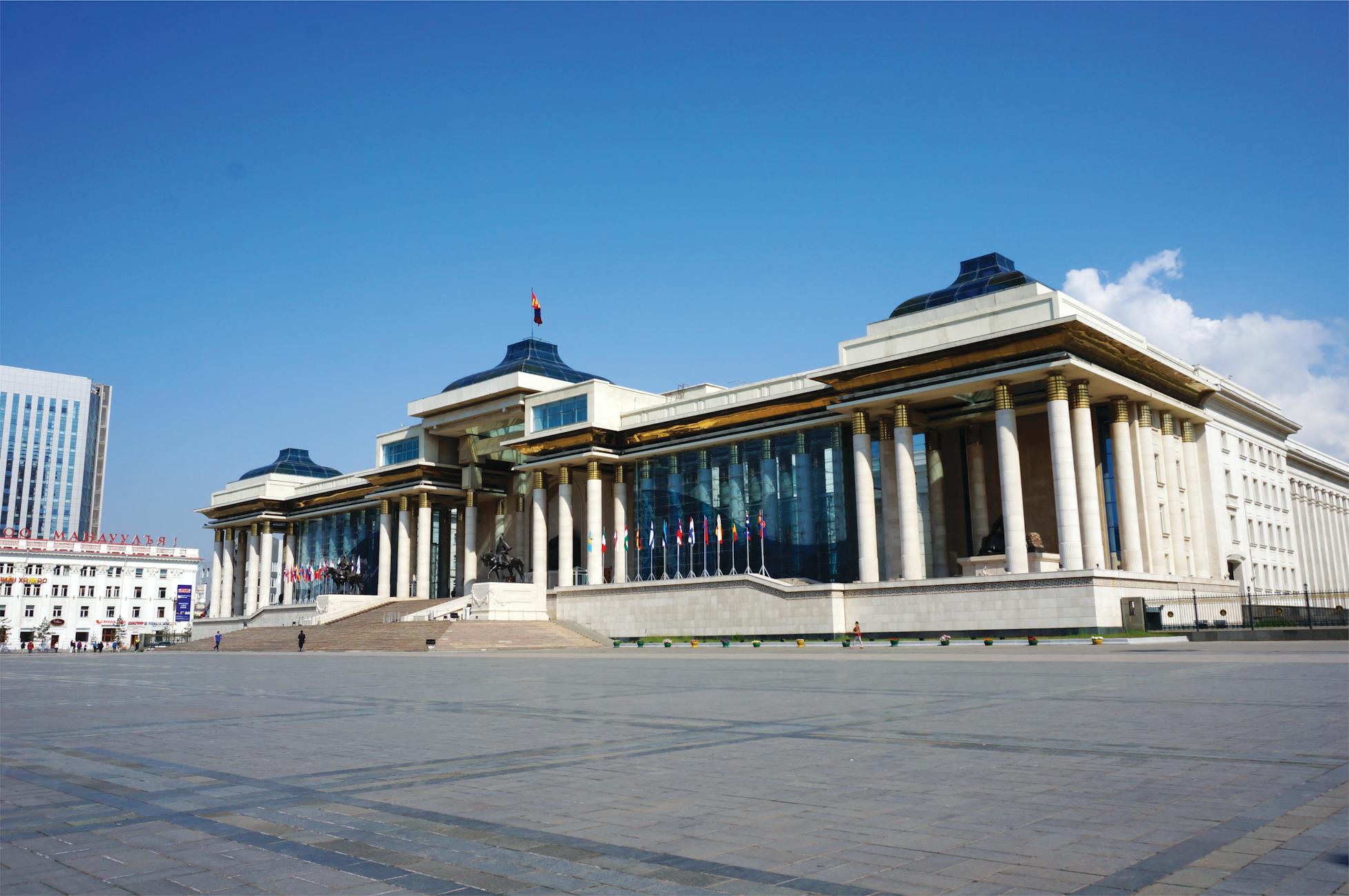 The Mongolian Government Palace in Sukhbaatar Square under a clear blue sky.