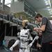 Technician working on humanoid robot at a tech exhibition in Guimaraes, Portugal.