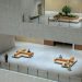 Spacious modern atrium in a Shanghai building featuring minimalistic design with people sitting and walking.