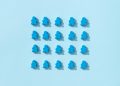 A minimalist pattern of blue meeple figures arranged on a plain background, conveying simplicity and organization.