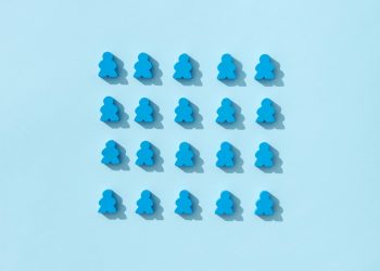 A minimalist pattern of blue meeple figures arranged on a plain background, conveying simplicity and organization.