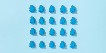 A minimalist pattern of blue meeple figures arranged on a plain background, conveying simplicity and organization.