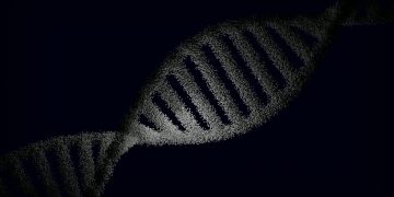 Artistic rendering of a DNA strand with particle effects against a dark background.