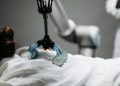 Close-up of a robotic massage arm applying therapy on a person, showcasing innovation.