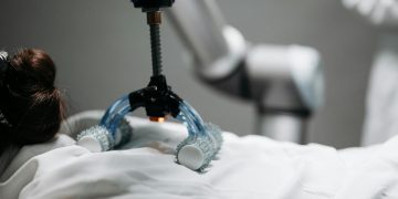 Close-up of a robotic massage arm applying therapy on a person, showcasing innovation.