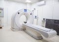 High-resolution image of a modern, clean MRI scanner room in a hospital facility.