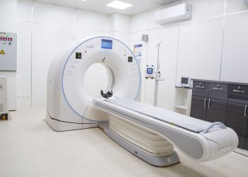 High-resolution image of a modern, clean MRI scanner room in a hospital facility.