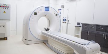 High-resolution image of a modern, clean MRI scanner room in a hospital facility.