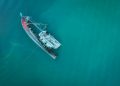 Aerial photograph of a sunken shipwreck in turquoise water near Chukai, Terengganu, Malaysia.